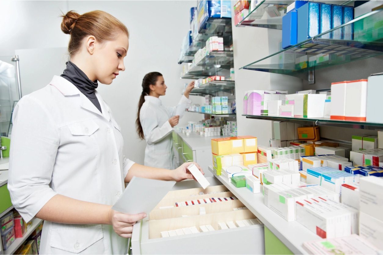 Two women are working in a pharmacy.